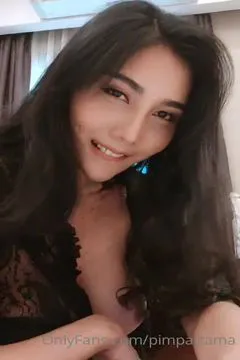 PimPattama of Thailand, a busty beauty, lifts up her black lace nightgown to reveal her fair body.
