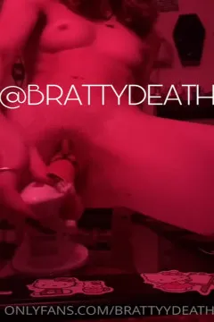 How does BrattyDeath, the dark beauty, pick up and stuff the meat stick?