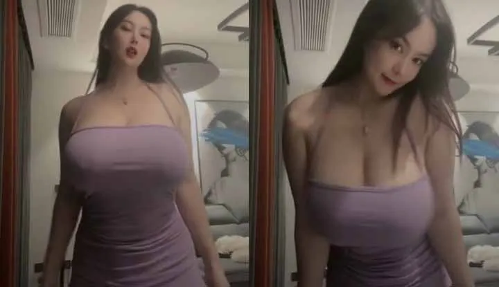 Busty model with huge headlights - her clothes are almost bursting at the seams.